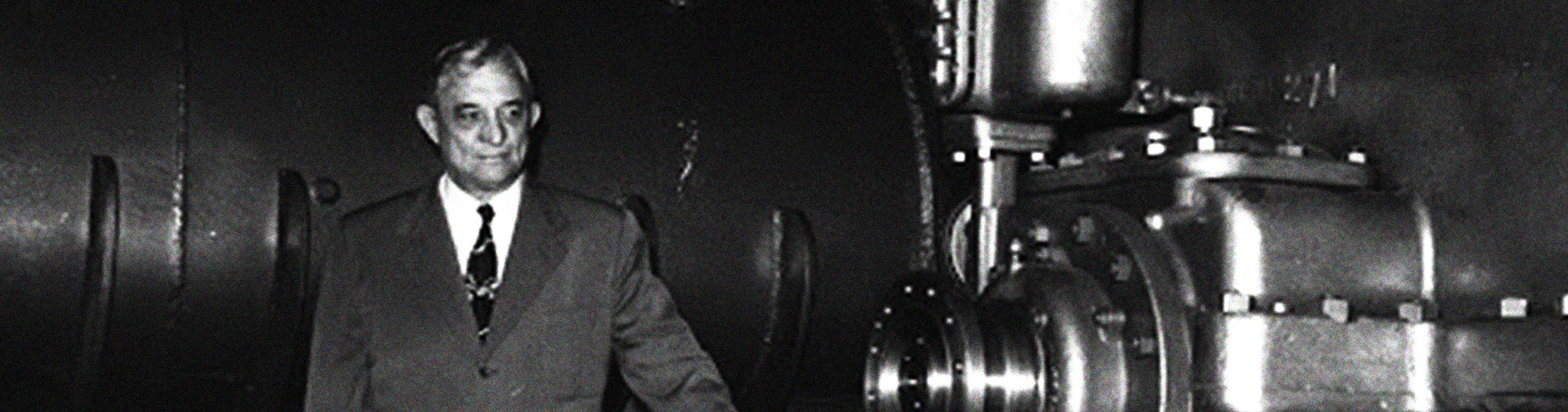 carrier-service-technician-in-equipment-room-servicing-panel-crop